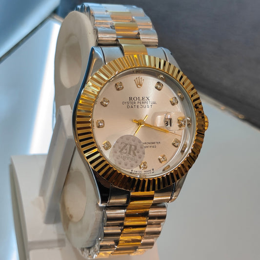 Two-tone watch with a gold and silver band on a stand against a neutral background